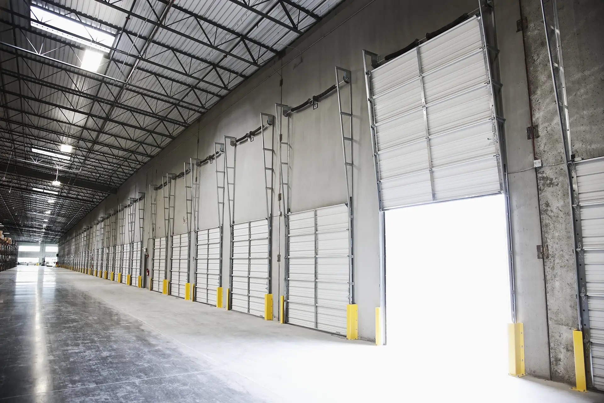 side view of white garage doors with one open