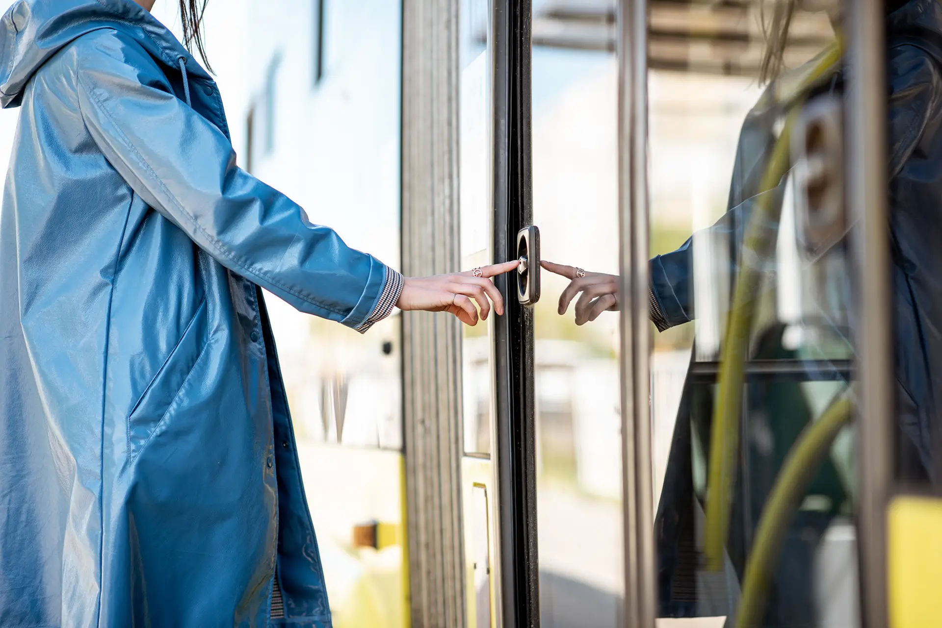 woman's hand touching door bell