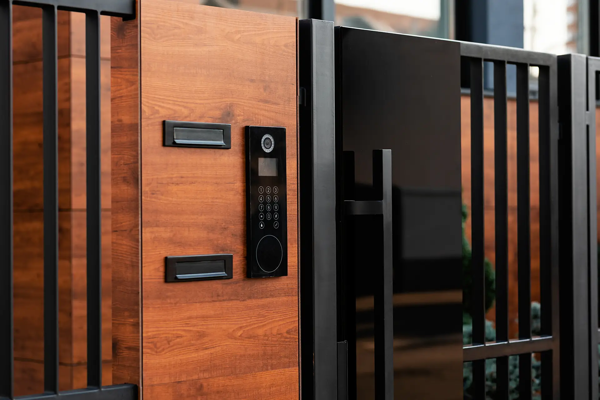 black metal gate door with wood and speaker box