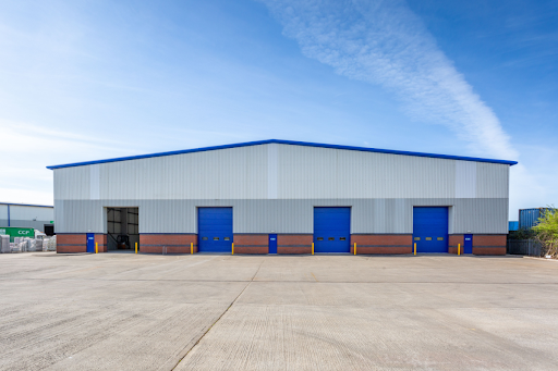 Exterior shot of a commercial facility with 4 commercial doors